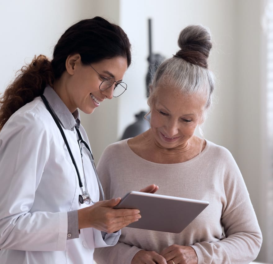 patient and doctor looking at electronic device